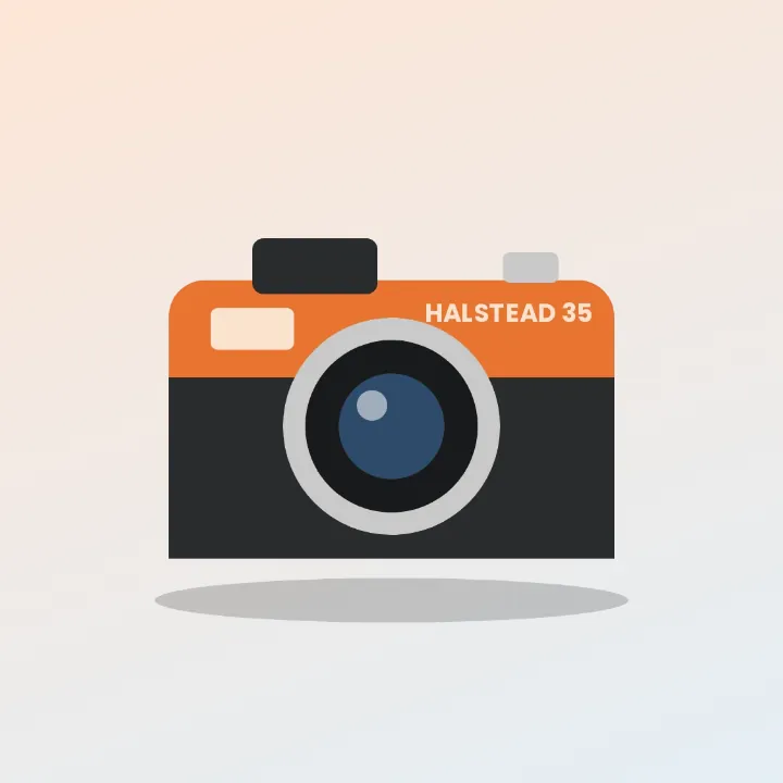An orange Halstead 35 film camera with a soft shadow under it