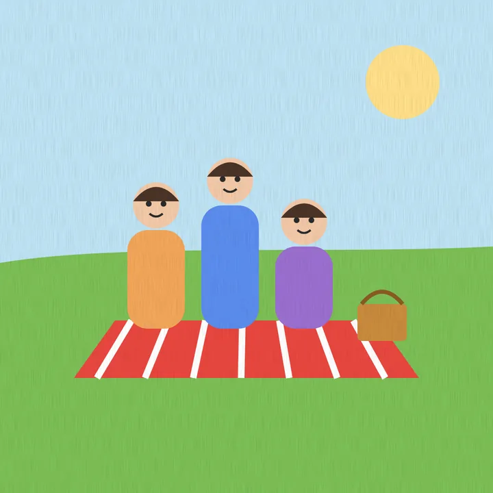 A family of three on a red picnic blanket in a park