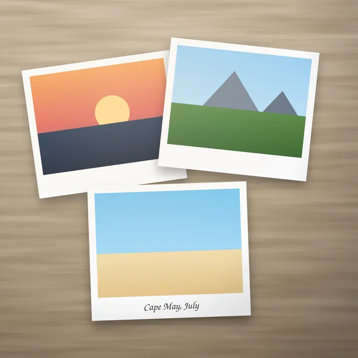 Three printed trip photos on a table: a sunset, mountains, and a beach captioned Cape May, July