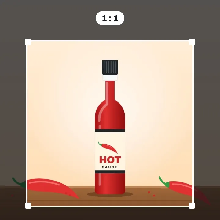 A red hot sauce bottle with chili peppers on a wooden board, a square crop frame drawn around it, the parts outside dimmed